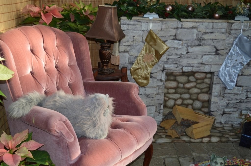 Armchair by a fireplace with Christmas stockings