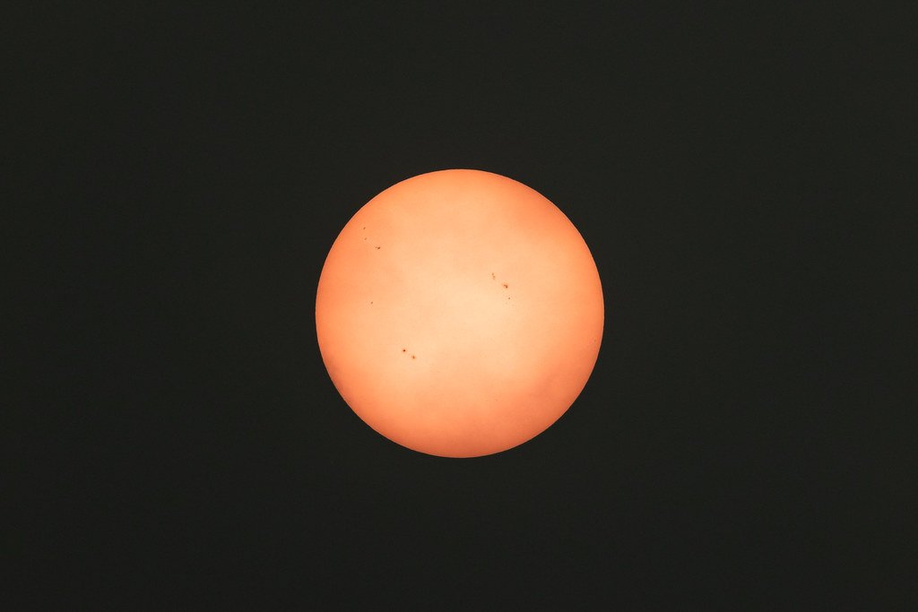 Sun turned orange by wildfire smoke haze