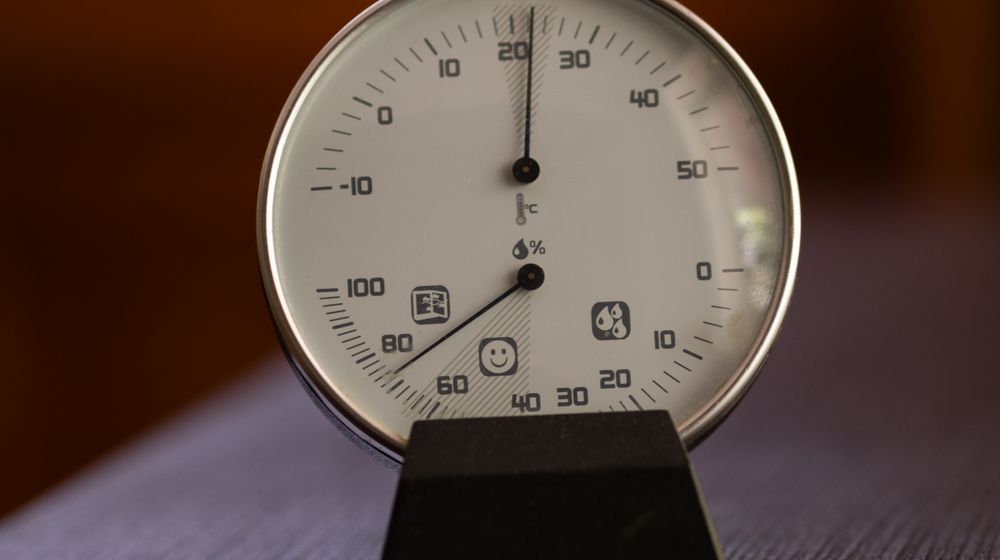 Analog hygrometer dial showing relative humidity and temperature